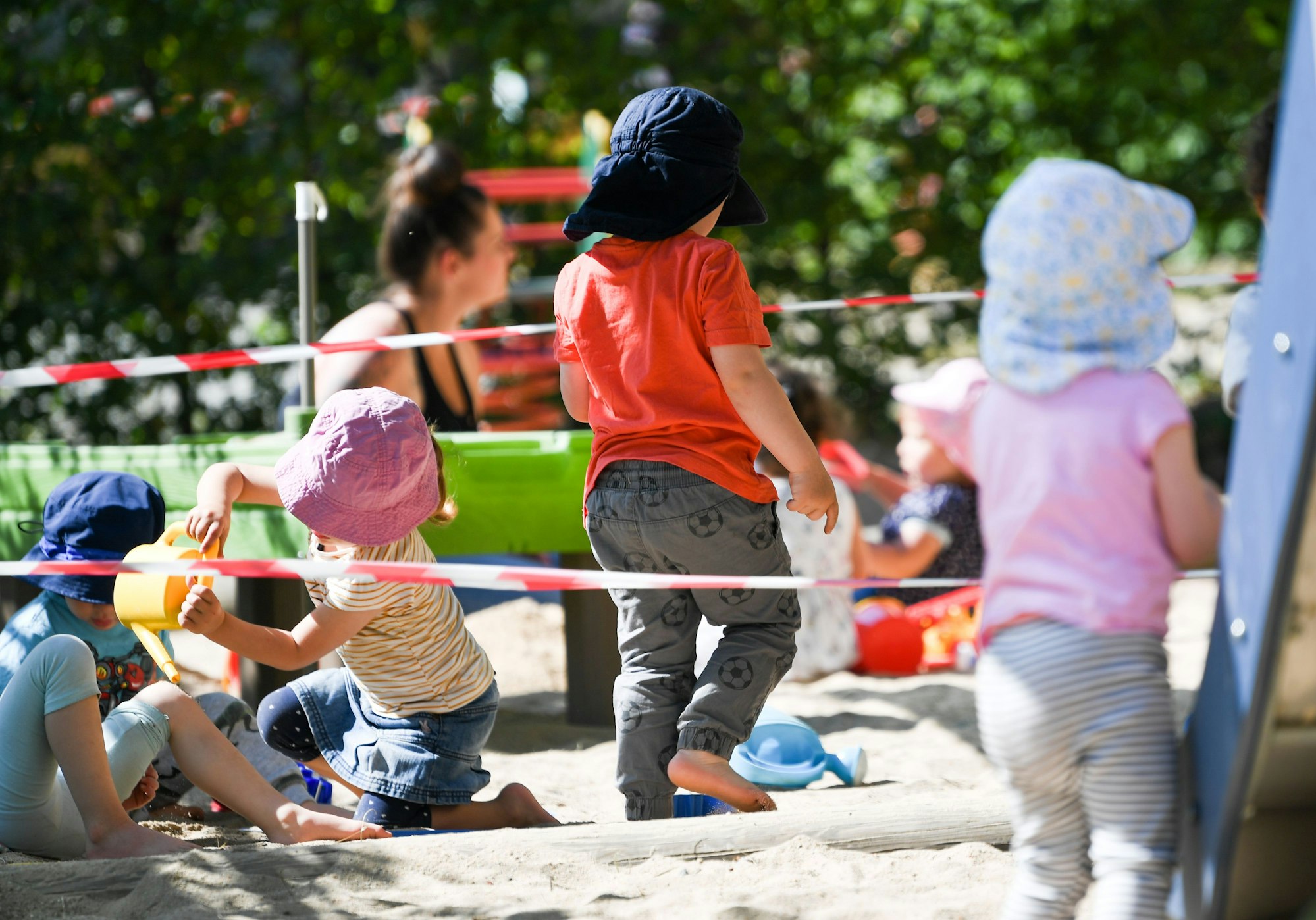 Kinder einer Krippen-Gruppe spielen auf dem Spielplatz der Kita. Dabei werden sie je nach Ort von unterschiedlich stark qualifiziertem Personal betreut. (Symbolbild)