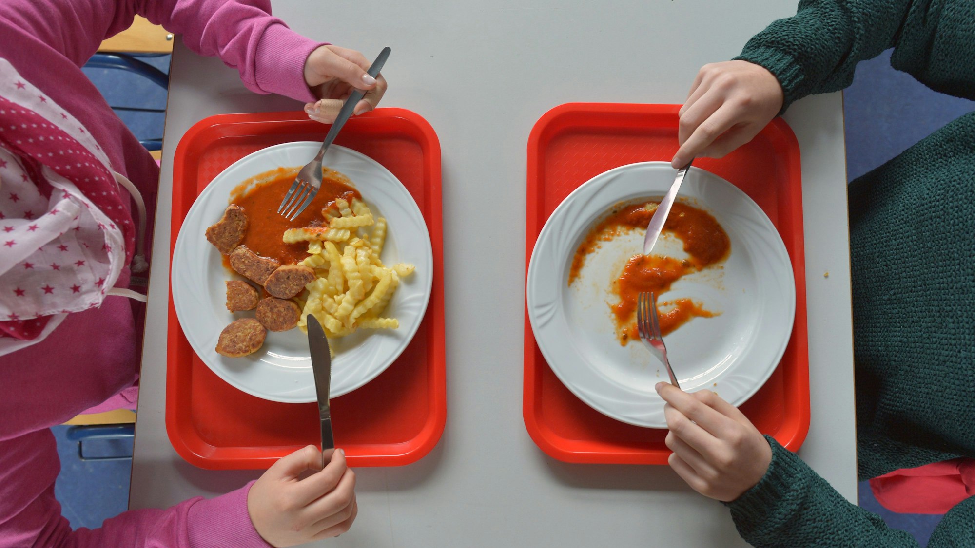 Schüler nehmen in der Schulpause eine warme Mahlzeit zu sich.