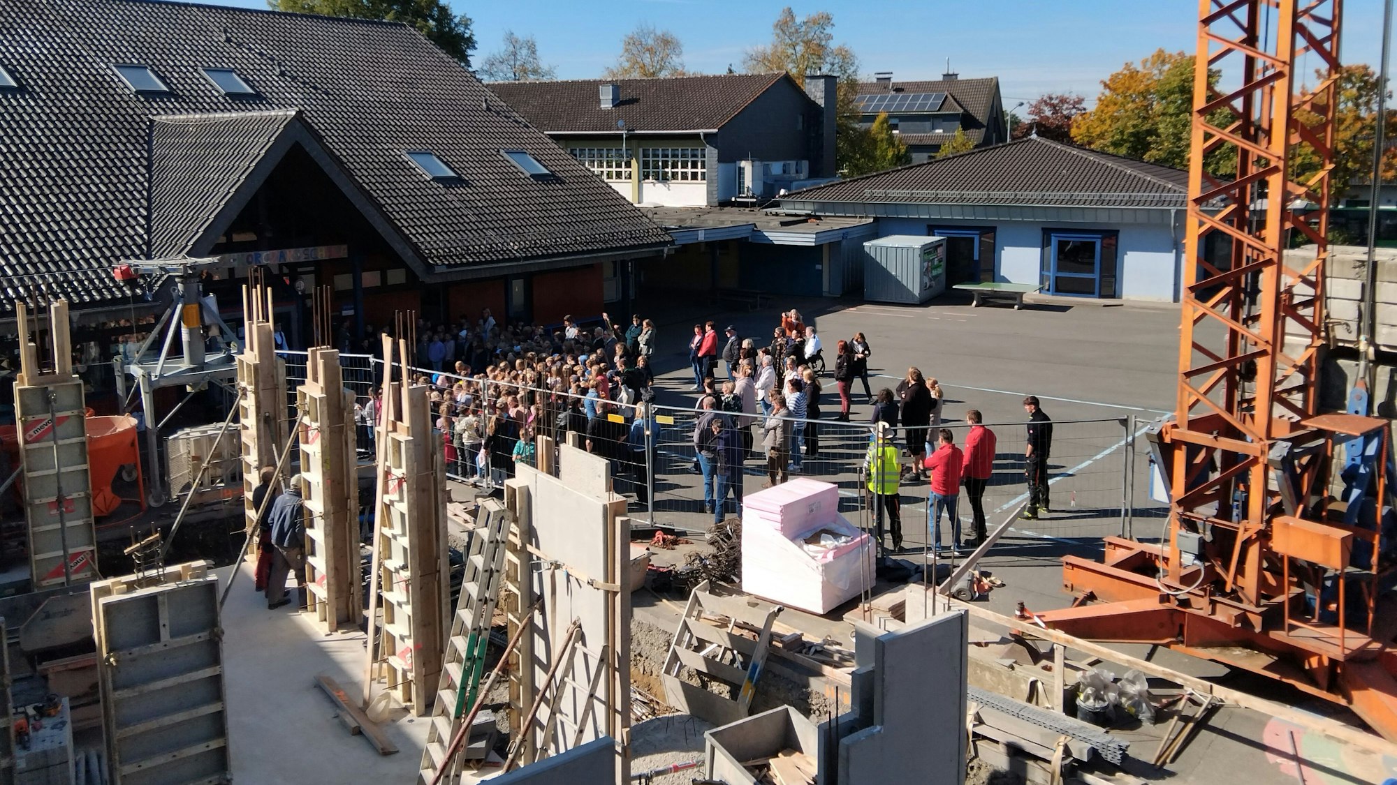 Beim Richtfest der Grundschule Much-Marienfeld sangen die Kinder ein Lied. Das erste Gebäude steht im Rohbau, das zweite wächst auf dem Schulhof.