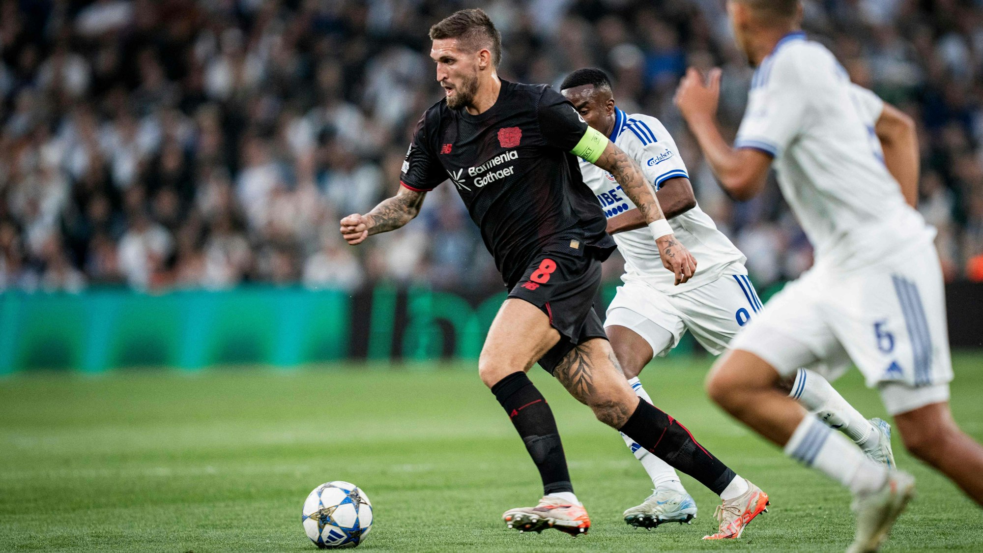 TOPSHOT - Bayer Leverkusen's German midfielder #08 Robert Andrich (L) controls the ball during the UEFA Champions League league phase day 1 football match between FC Copenhagen and Bayer Leverkusen in Copenhagen, Denmark, on September 18, 2025. (Photo by Sebastian Elias Uth / Ritzau Scanpix / AFP) / Denmark OUT