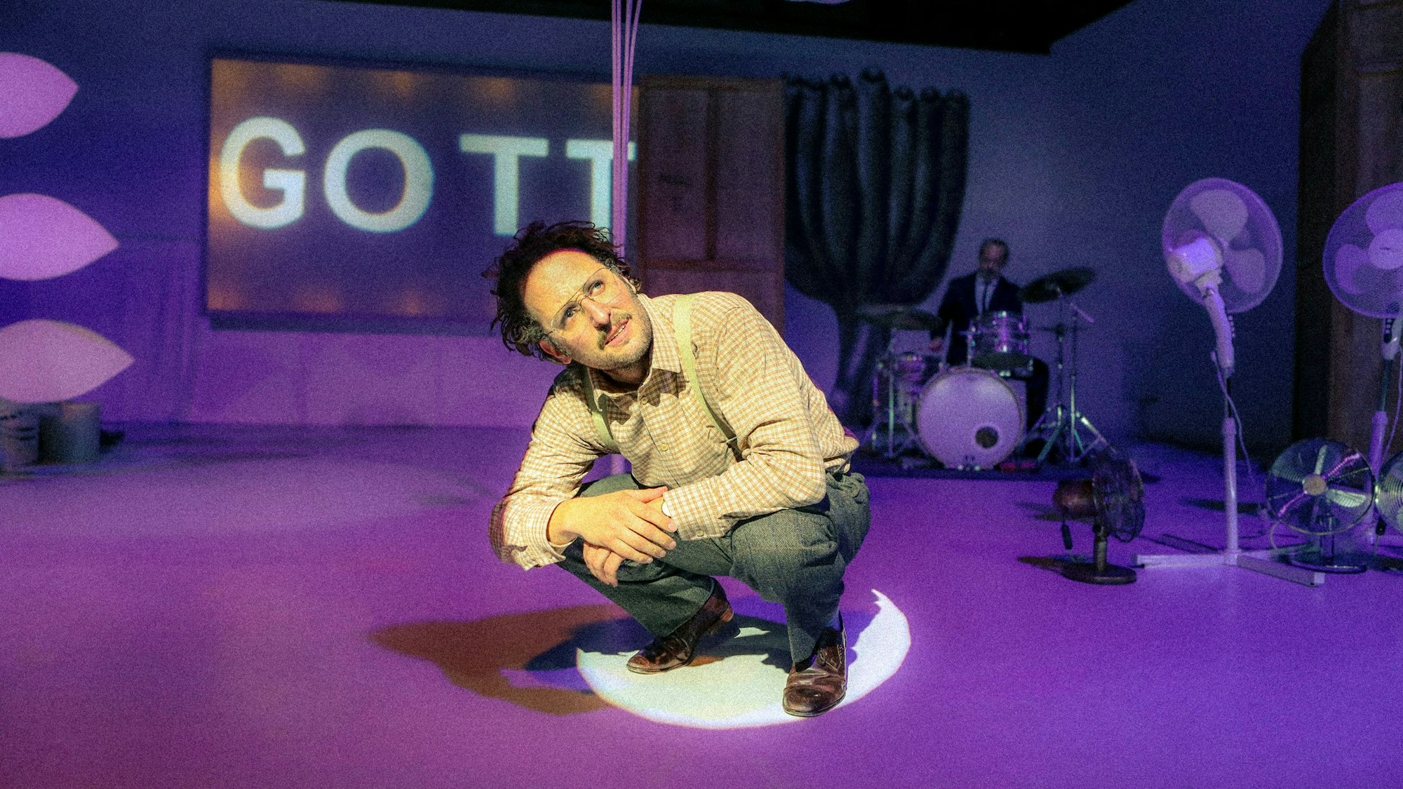 Bastian Reiber sitzt in der Hocke. Hinter ihm erscheint das Wort „Gott“