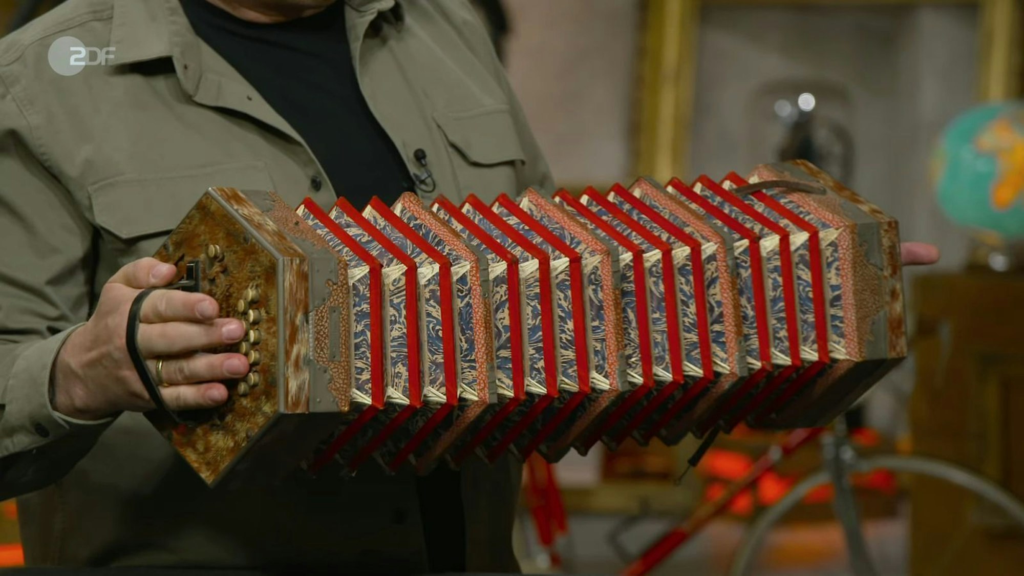 Made in Sachsen, stellte Experte Deutschmanek fest, als er den Stempel auf dem Instrument entdeckte. Die Konzertina stammte von der Traditionsfirma Meinel & Herold aus Klingenthal - und war mit ihren Details ein echtes Schmuckstück: Ein Leinenblasebalg mit Marmorpapier, Eisenbeschlägen, Lederriemen und Knöpfen aus Bein. (Bild: ZDF)