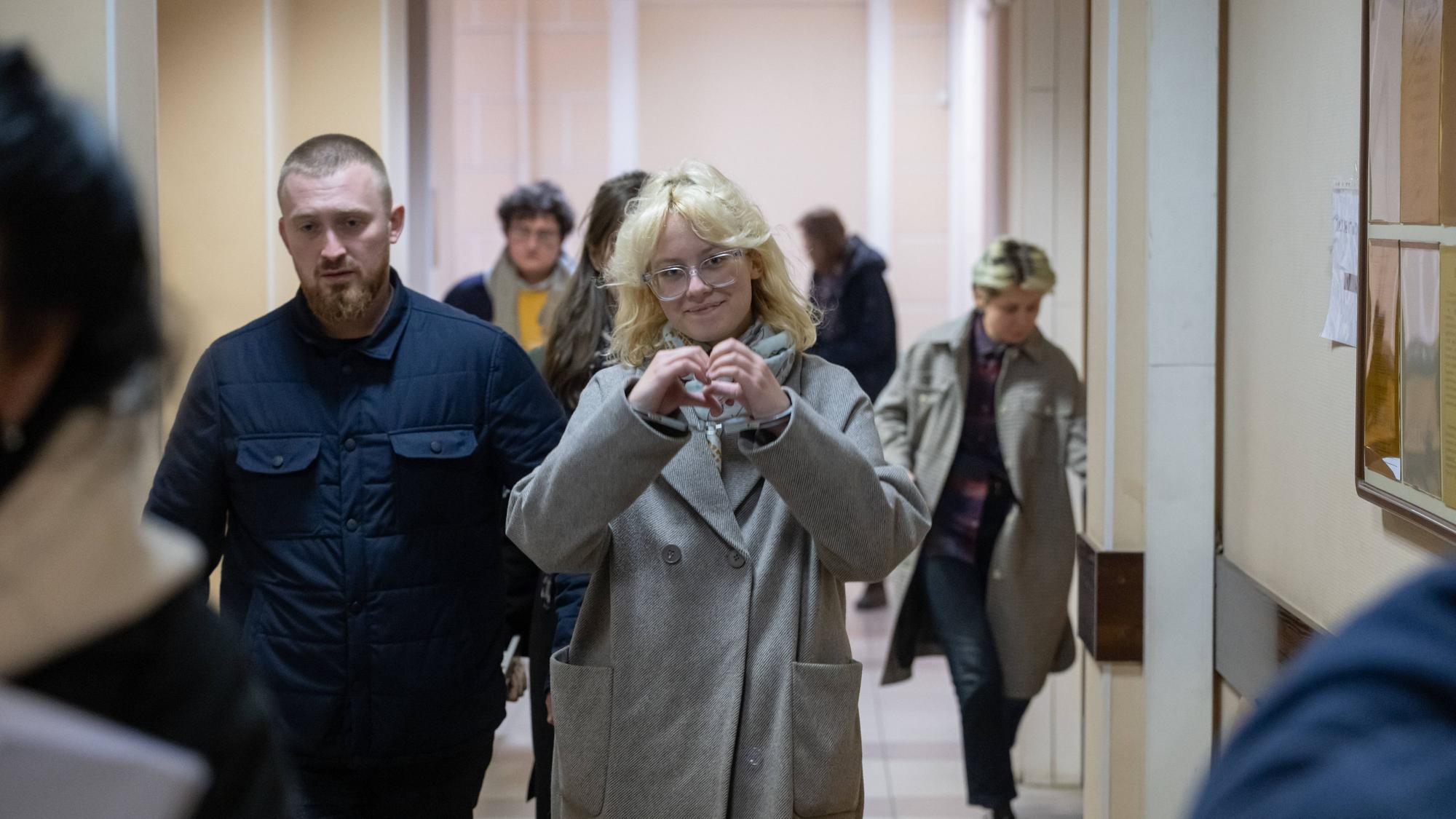 Ein Polizist führt die Sängerin Diana Loginowa (Künstlername Noako) in Handschellen in einen Gerichtssaal in Sankt Petersburg.