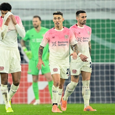 Leverkusen players including English defender #04 Jarell Quansah (L) and Spanish defender #20 Alejandro Grimaldo react during the German Cup (DFB Pokal) second round football match between SC Paderborn and Bayer 04 Leverkusen in Paderborn, western Germany on October 29, 2025. (Photo by INA FASSBENDER / AFP) / DFB REGULATIONS PROHIBIT ANY USE OF PHOTOGRAPHS AS IMAGE SEQUENCES AND QUASI-VIDEO.