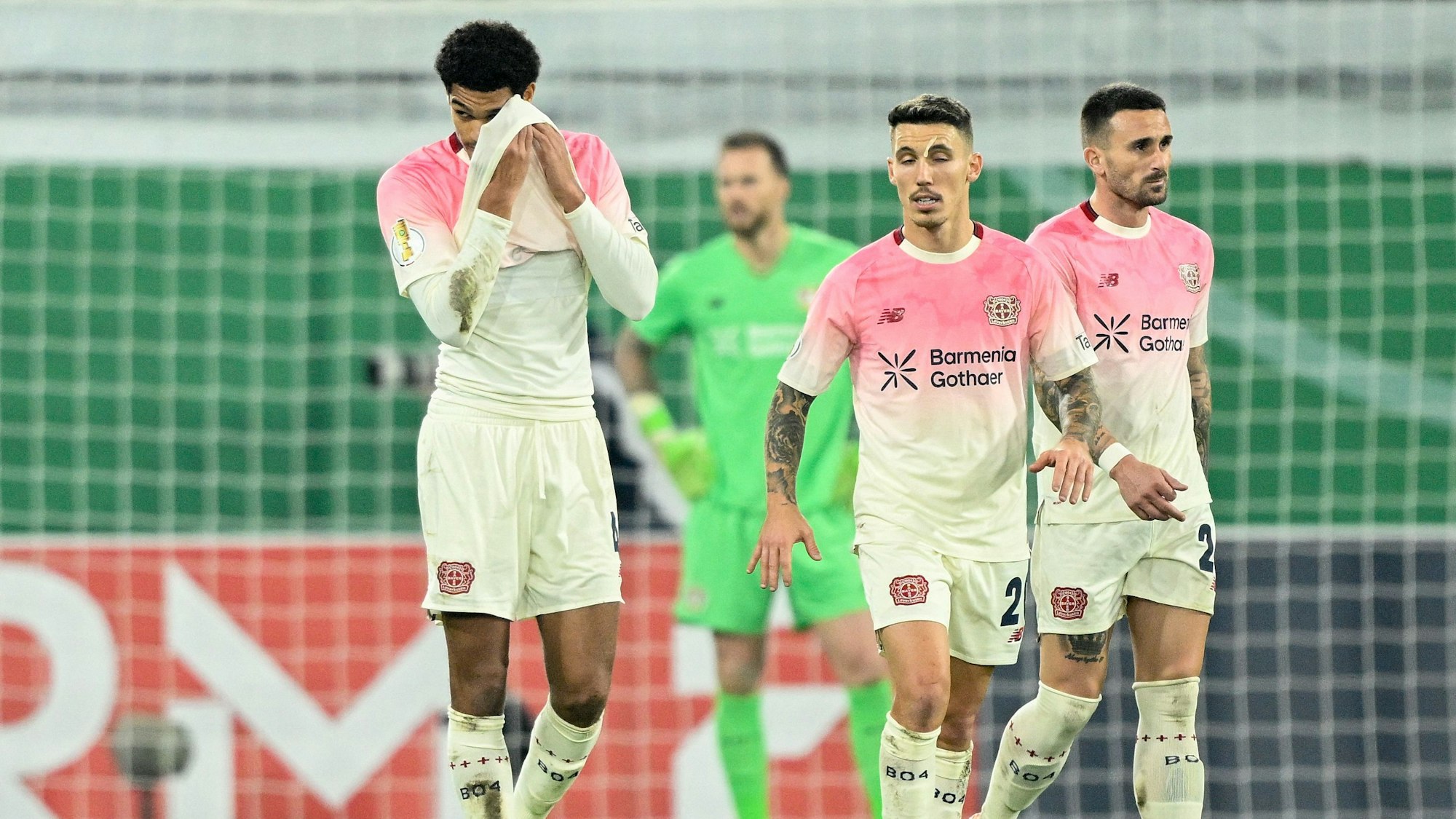 Leverkusen players including English defender #04 Jarell Quansah (L) and Spanish defender #20 Alejandro Grimaldo react during the German Cup (DFB Pokal) second round football match between SC Paderborn and Bayer 04 Leverkusen in Paderborn, western Germany on October 29, 2025. (Photo by INA FASSBENDER / AFP) / DFB REGULATIONS PROHIBIT ANY USE OF PHOTOGRAPHS AS IMAGE SEQUENCES AND QUASI-VIDEO.
