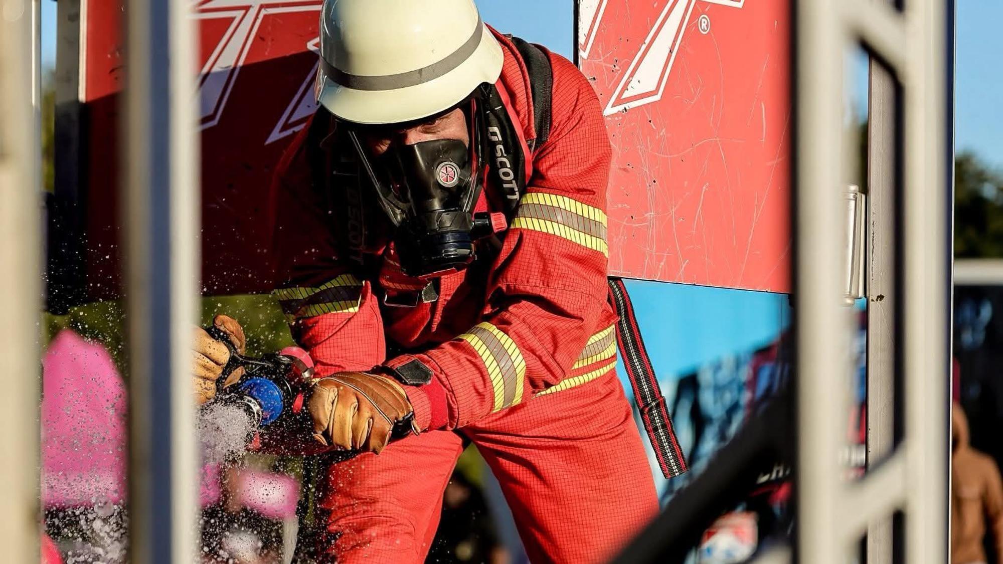 Ein Feuerwehrmann in roter Einsatzkleidung.