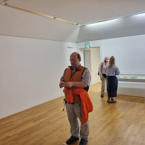 Ein sehbehinderter Mann steht in einem Kunstmuseum.
