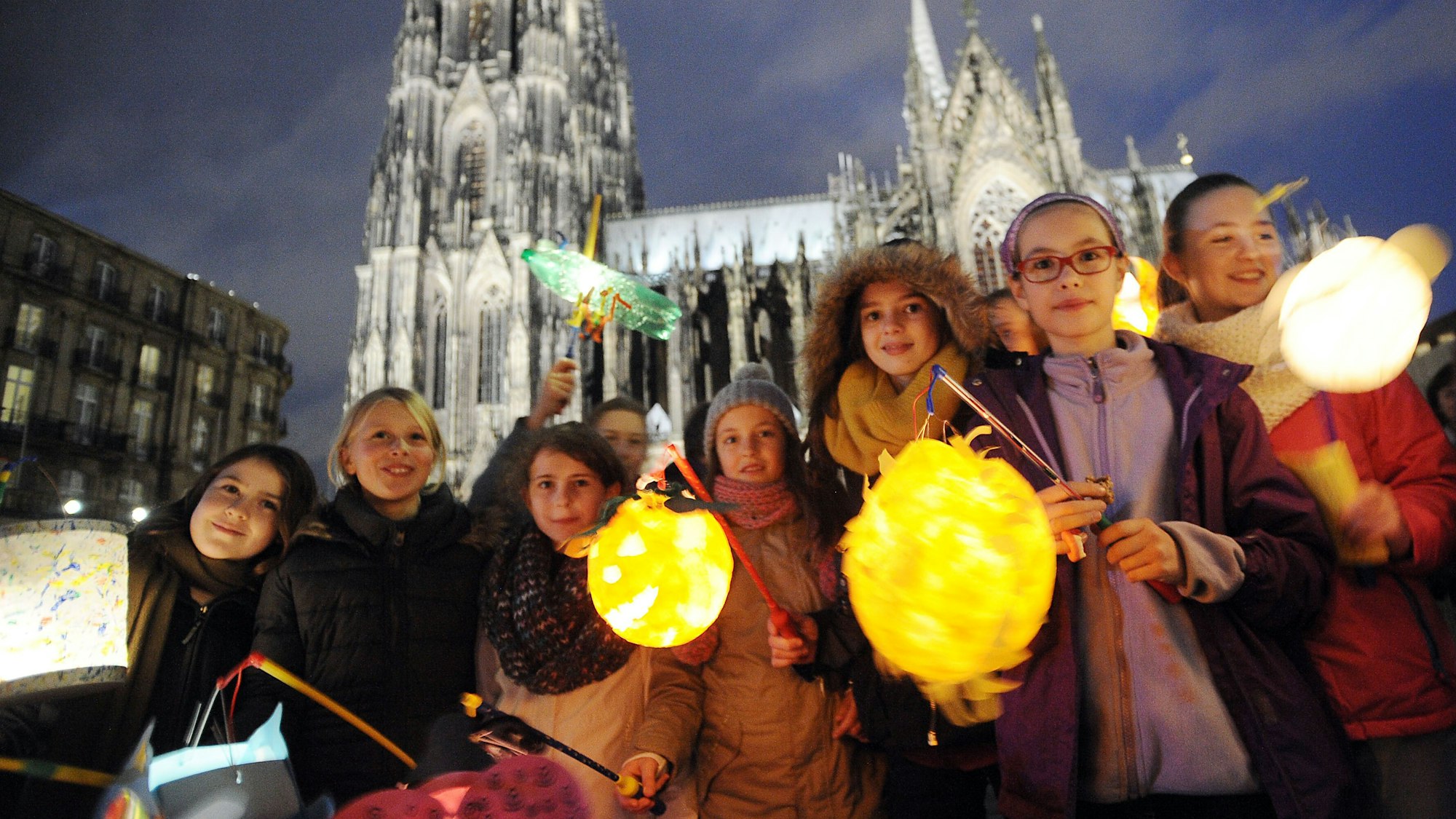 Kinder halten am 08.11.2013 in Köln (Nordrhein-Westfalen) bei einem Martinszug in der Innenstadt ihre Laternen.