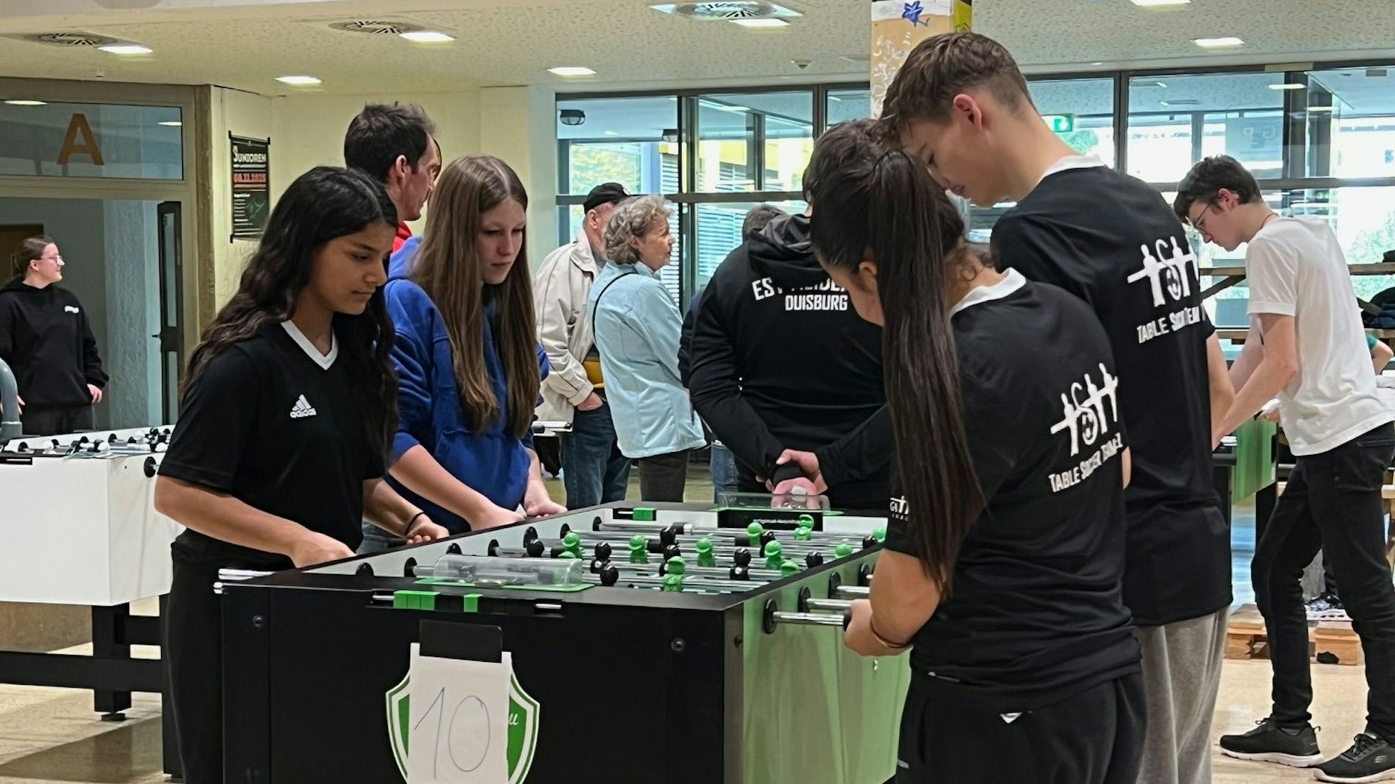 Das Foto zeigt die Jugendlichen am Tischkicker.