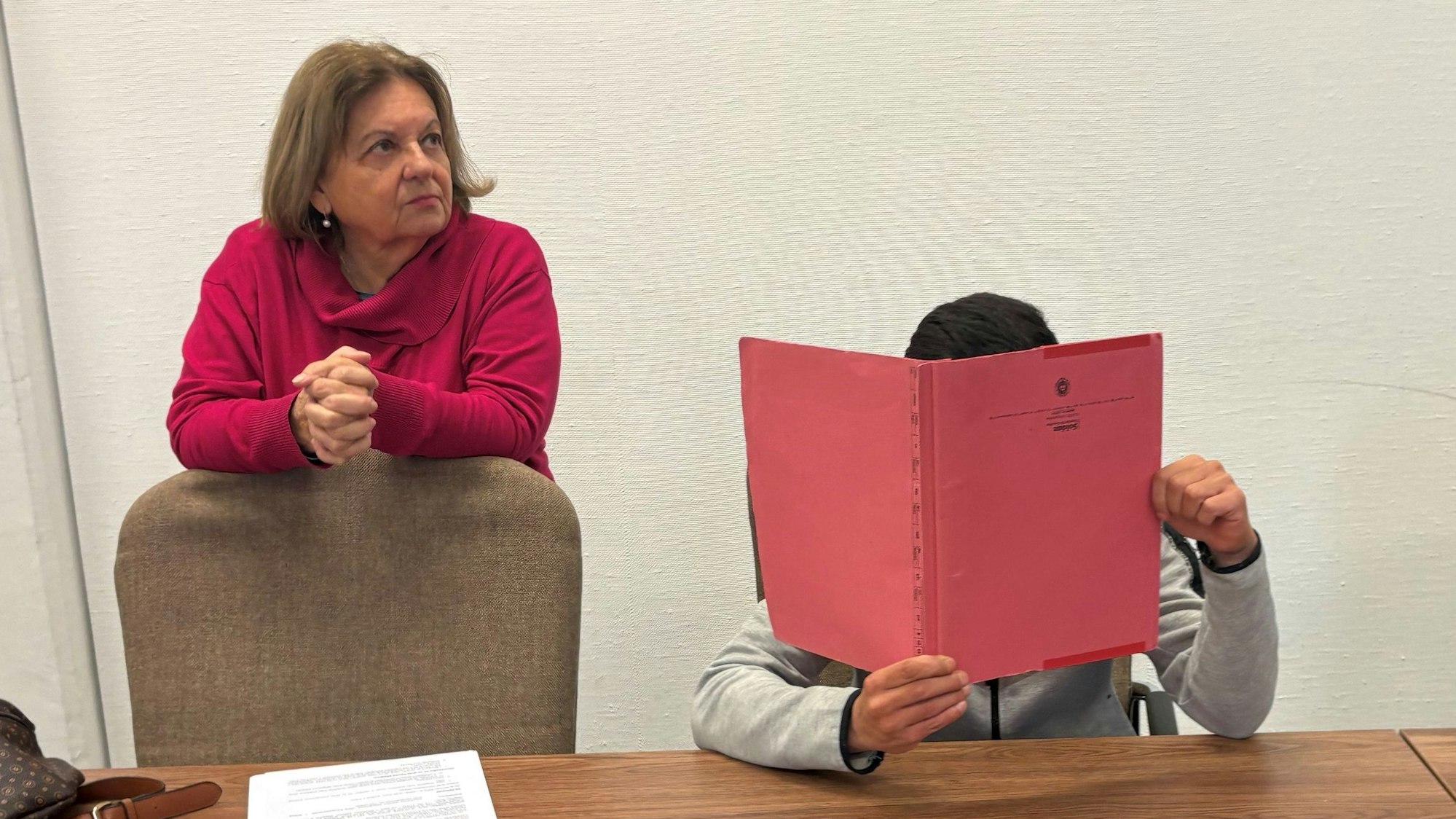 Der geständige Einbrecher mit einer Dolmetscherin beim Prozessauftakt im Kölner Landgericht.