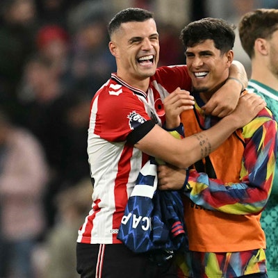 TOPSHOT - Sunderland's Swiss midfielder #34 Granit Xhaka (L) jokes with Arsenal's Ecuadorian defender #05 Piero Hincapie (R) after the final whistle during the English Premier League football match between Sunderland and Arsenal at The Stadium of Light in Sunderland in north east England on November 8, 2025. (Photo by Oli SCARFF / AFP) / RESTRICTED TO EDITORIAL USE. No use with unauthorized audio, video, data, fixture lists, club/league logos or 'live' services. Online in-match use limited to 120 images. An additional 40 images may be used in extra time. No video emulation. Social media in-match use limited to 120 images. An additional 40 images may be used in extra time. No use in betting publications, games or single club/league/player publications. /