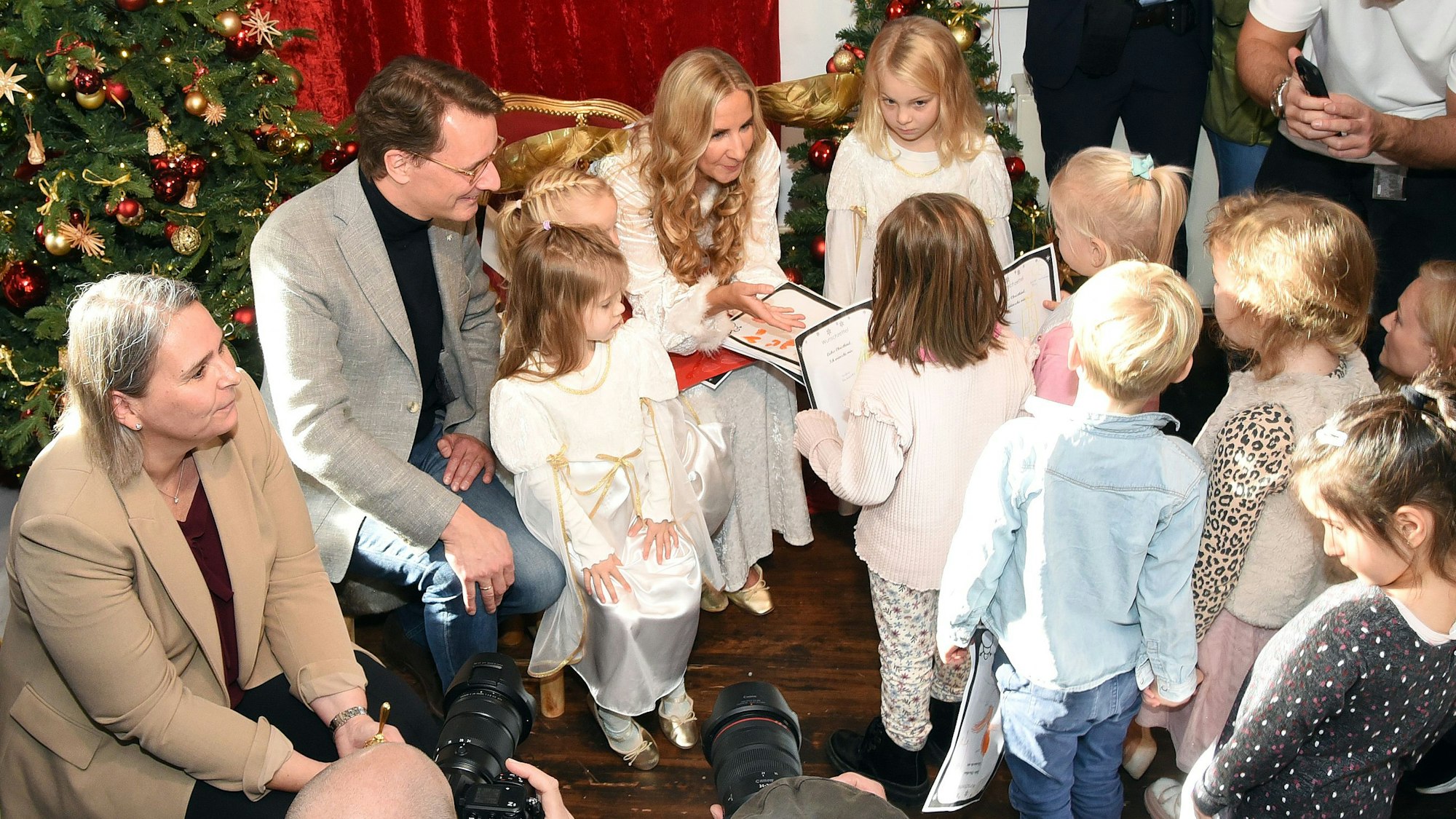 Kindergartenkinder stehen in einer Schlange, um ihre Wunschzettel abzugeben.