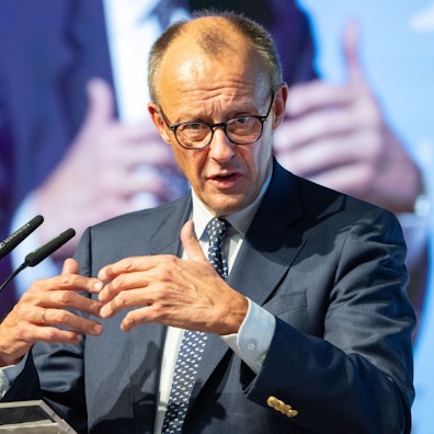 Bundeskanzler Friedrich Merz hält eine Rede am Pult.