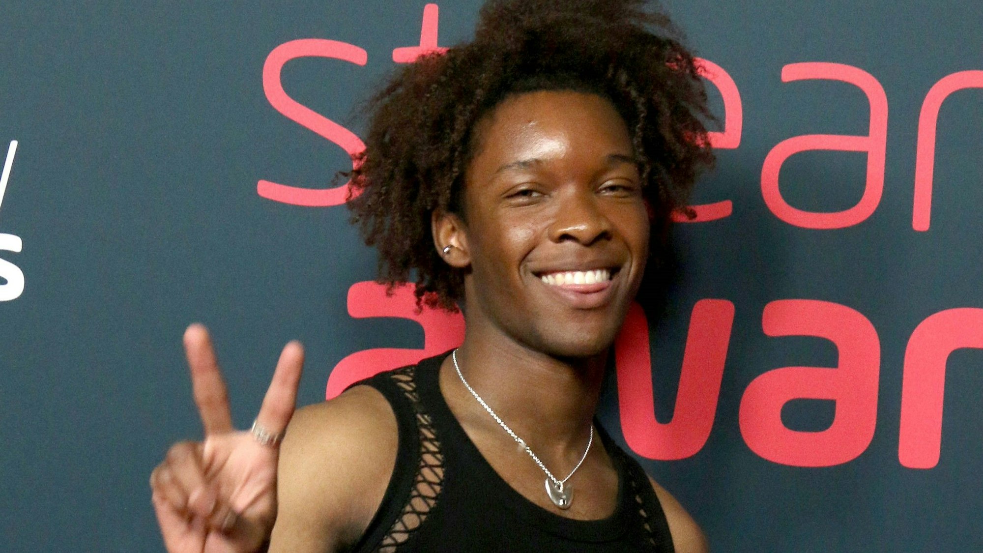 Der Rapper D4vd macht eine Peace-Zeichen mit den Fingern.