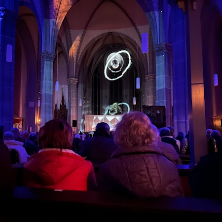 In einem Kirchenraum sind besondere ellipsenförmige Lichteffekte zu sehen.