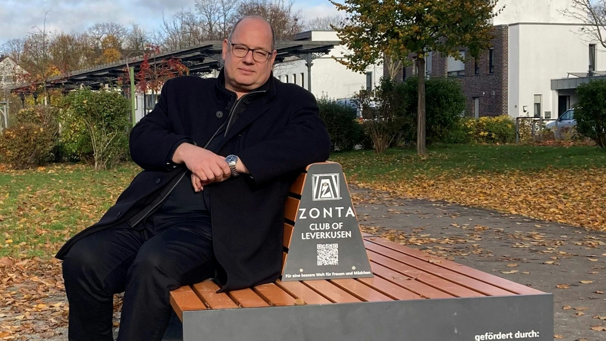 Oberbürgermeister Stefan Hebbel sitzt auf der Zonta-Bank in Opladen und spricht über die Gleichstellung von Frau und Mann.