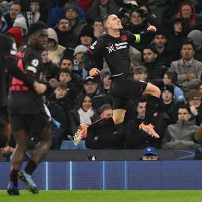 TOPSHOT - Bayer Leverkusen's Spanish defender #20 Alejandro Grimaldo celebrates after scoring the opening goal during the UEFA Champions League league-stage football match between Manchester City and Bayer Leverkusen at the Etihad Stadium in Manchester, north west England, on November 25, 2025. (Photo by Oli SCARFF / AFP)