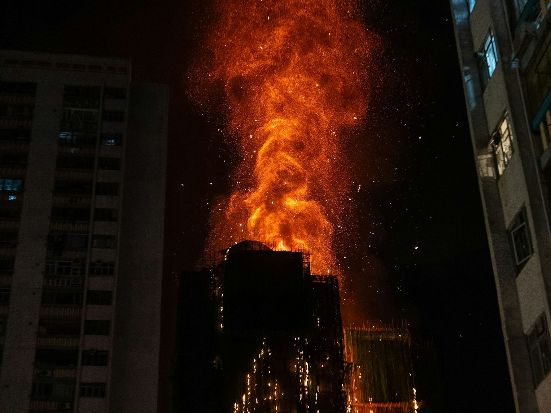 Nach einem Brand im Wang Fuk Court, einer Wohnsiedlung im Stadtteil Tai Po in den New Territories von Hongkong, schlagen Flammen aus einem Gebäude.