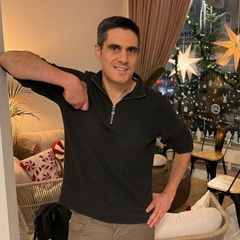 Zu sehen ist Alain Hermann vor weihnachtlicher Kulisse.