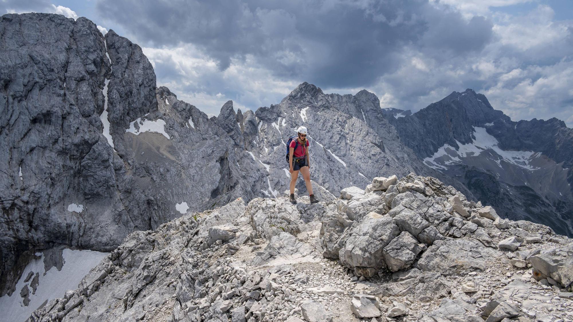 Ein Alpinist geht zwischen Zugspitze und Alpspitze.