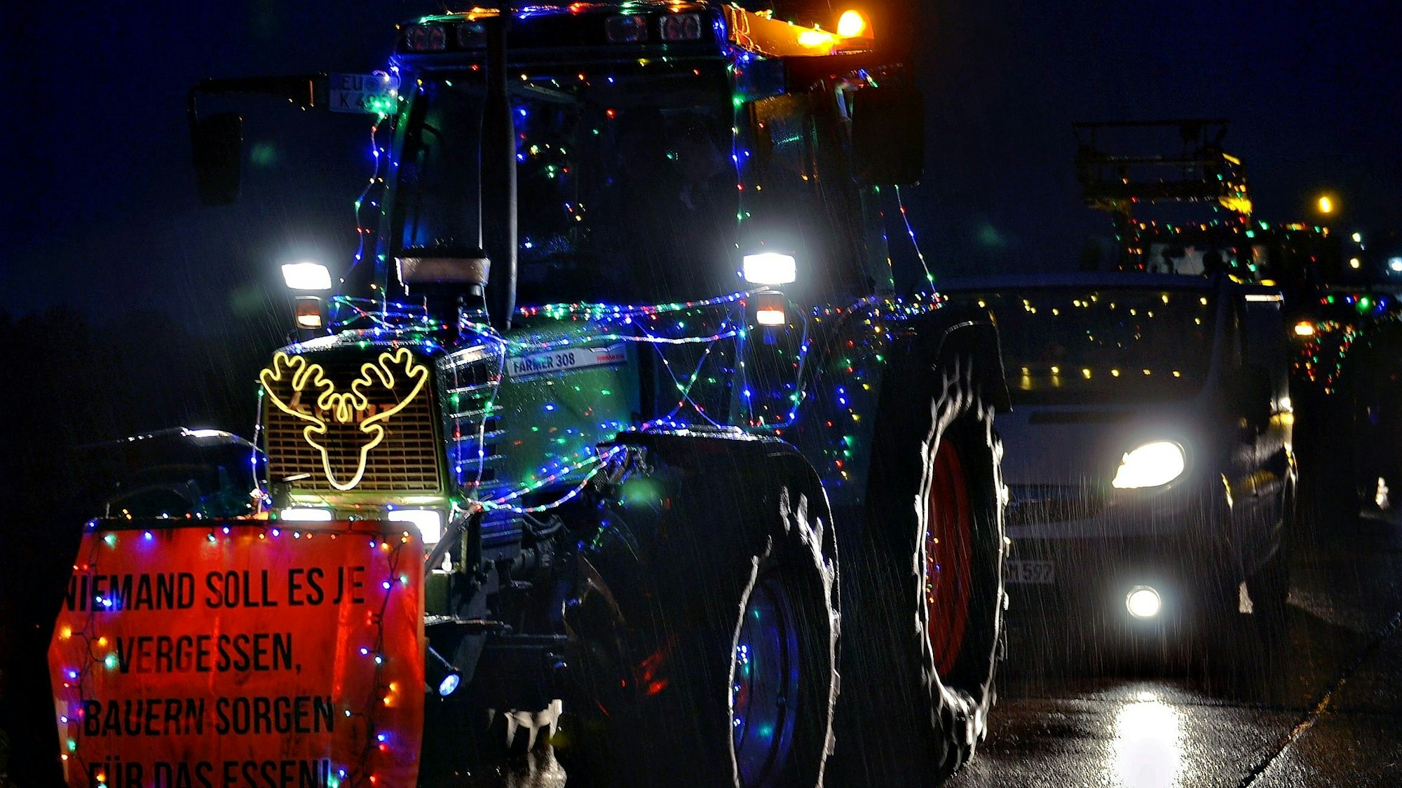 Das Bild zeigt einen mit Lichterketten geschmückten Traktor.