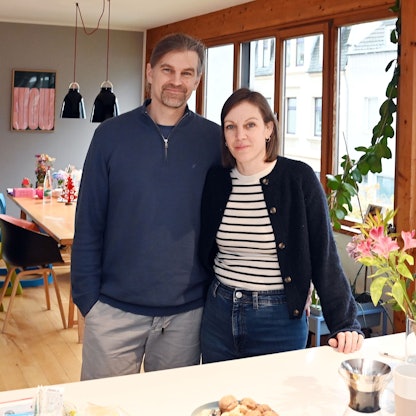 Die Eltern, Julischka und Sebastian stehen am Küchentisch und schauen in die Kamera.