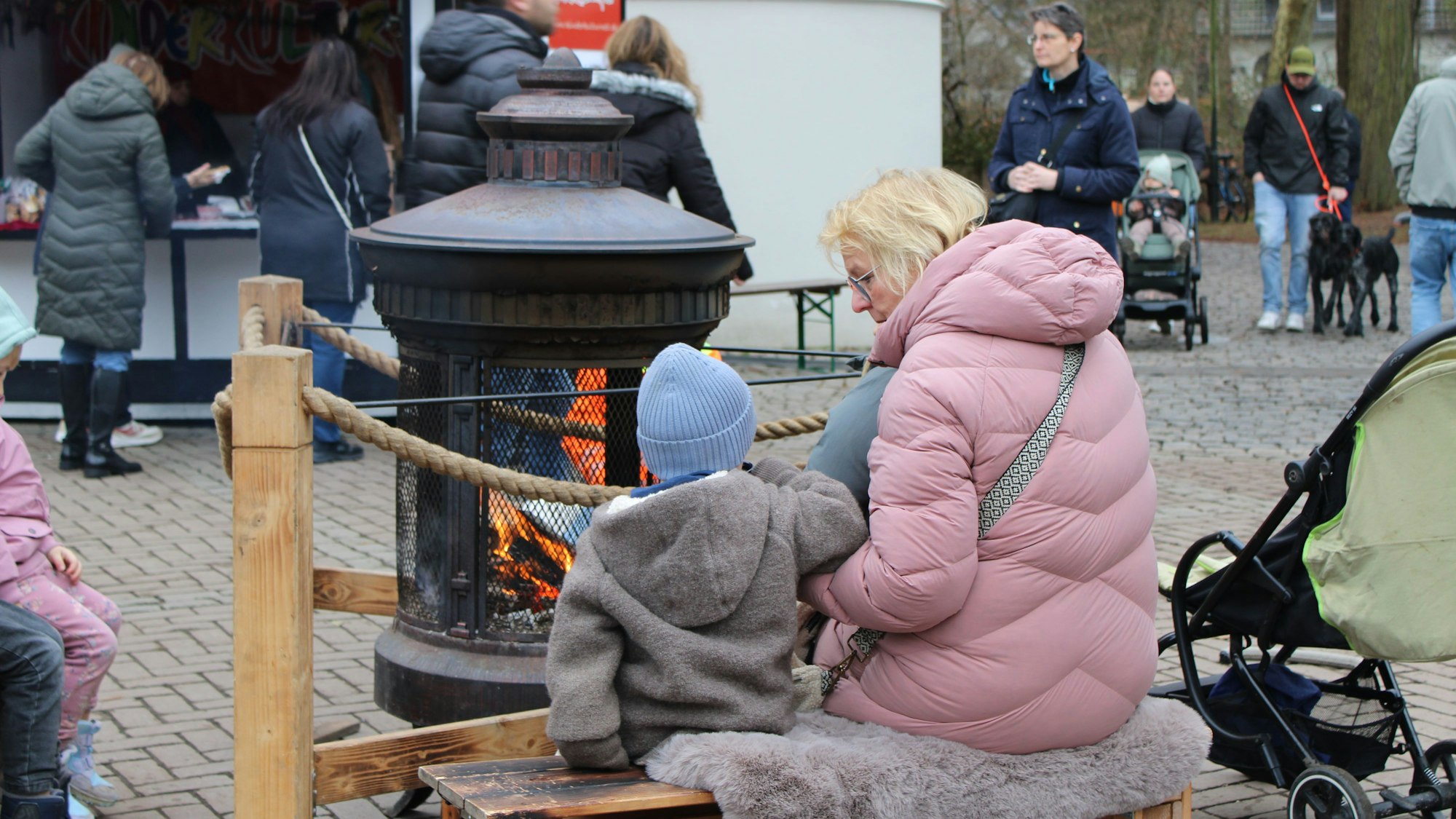 Weihnachtsmarkt auf der Troisdorfer Burg Wissem: Kinder tummeln sich um die wärmende Feuerstelle