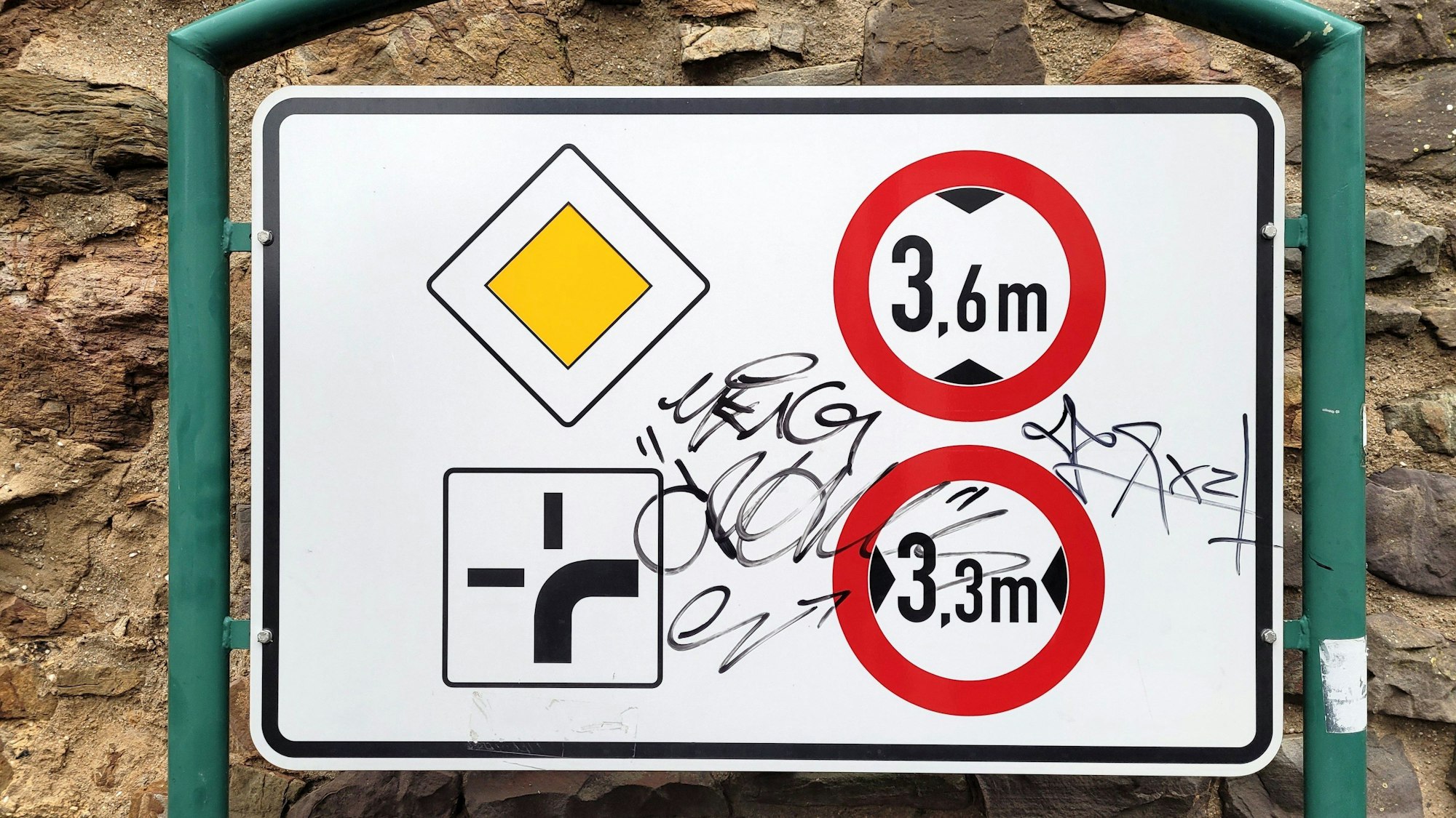 Auf einem Verkehrsschild sind Filzstift-Kritzeleien zu erkennen.