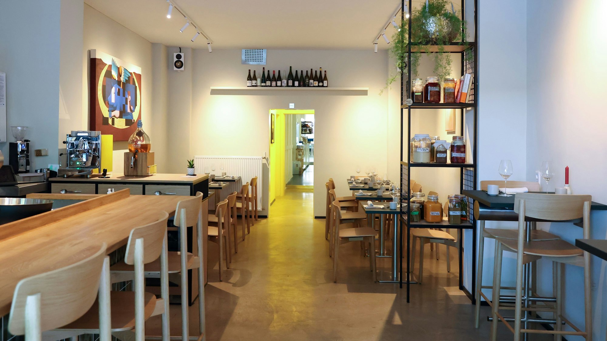 Ein Gastraum mit hellen Holztischen und skandinavischem Look.