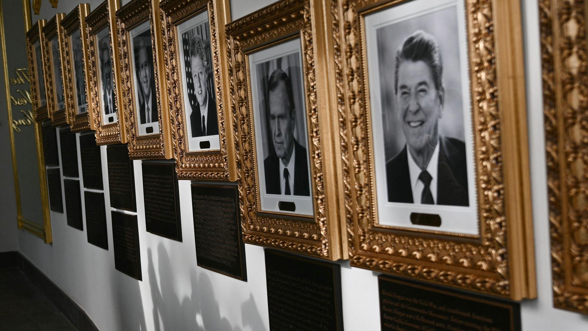 Portraits with new plaques of explanatory text are seen on the Presidential Walk of Fame on the Colonnade of the White House in Washington, DC, on December 17, 2025. (Photo by Brendan SMIALOWSKI / AFP)