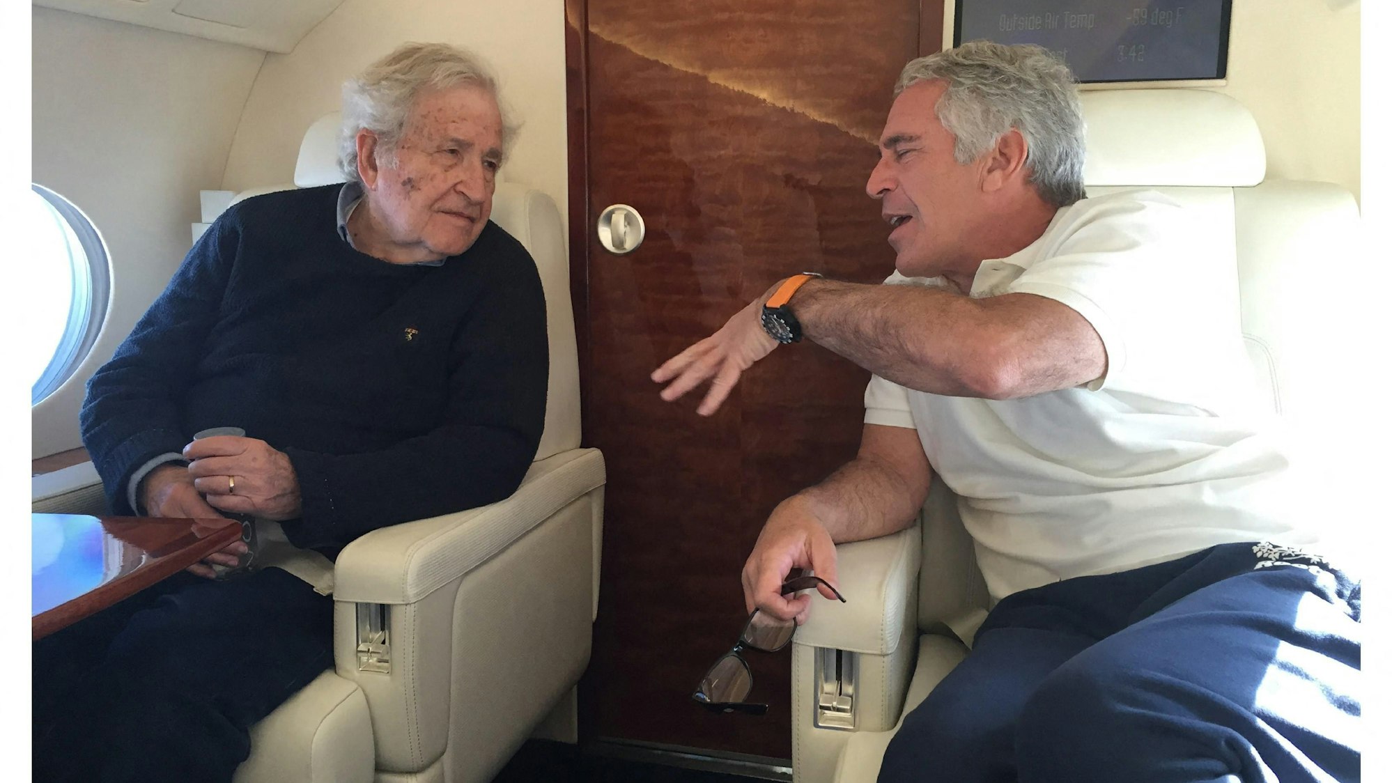 This undated and unlocated handout image released by Democrats on the House Oversight Committee on December 18, 2025 shows late convicted sex offender Jeffrey Epstein (R) speaking to US professor and political activist Noam Chomsky. Democratic lawmakers released a new cache of photos and documents on December 18 from the estate of convicted sex offender Jeffrey Epstein.