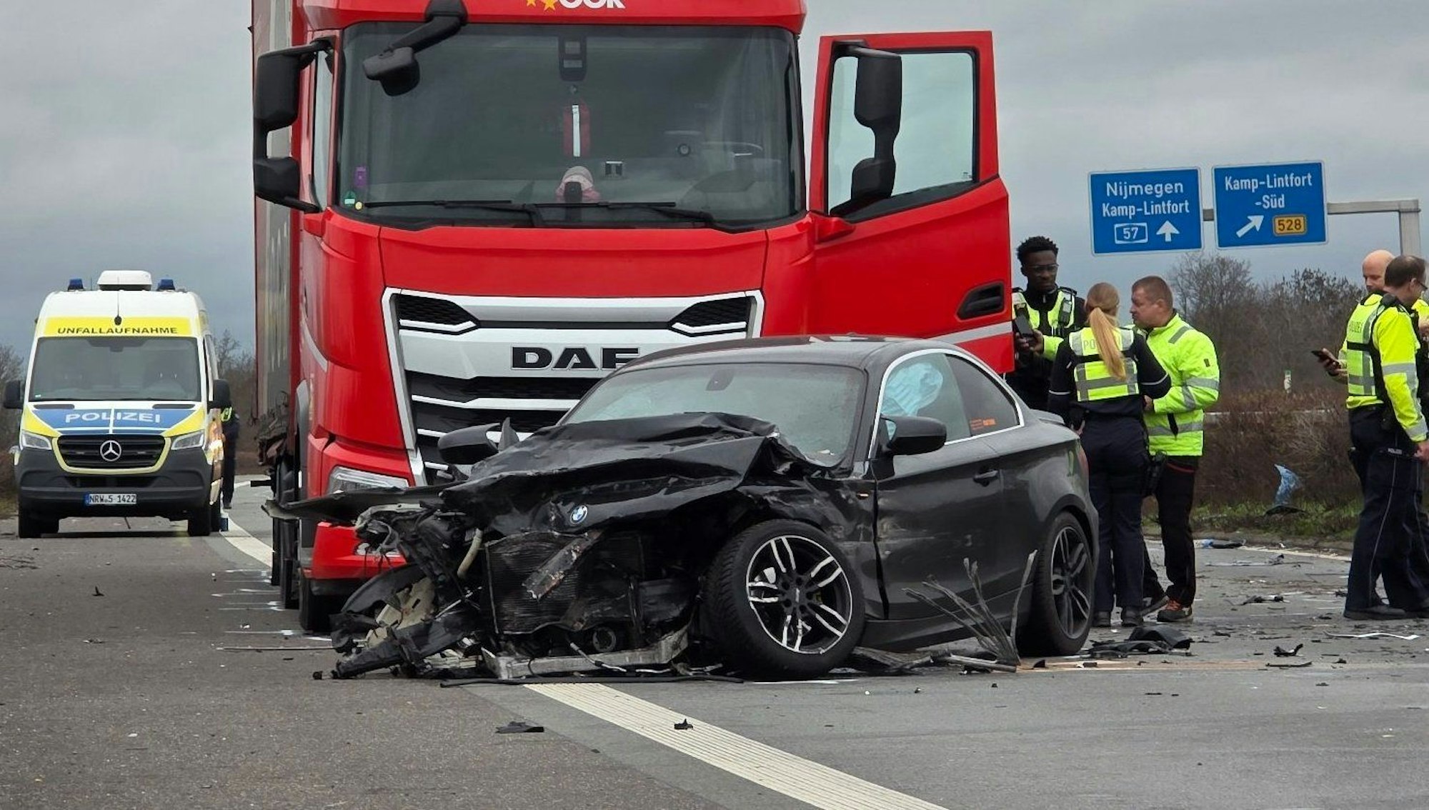 Polizisten stehen nach einem Unfall auf der Autobahn 57 an der Unfallstelle.