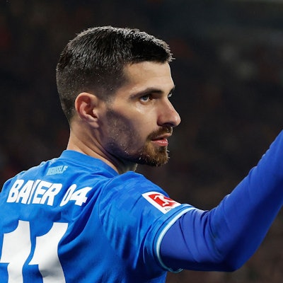 Bayer Leverkusen's French forward #11 Martin Terrier (L) celebrates scoring the 1-1 goal with his teammates during the German first division Bundesliga football match between RB Leipzig and Bayer 04 Leverkusen in Leipzig, eastern Germany, on December 20, 2025. (Photo by Odd ANDERSEN / AFP) / ALTERNATIVE CROP
