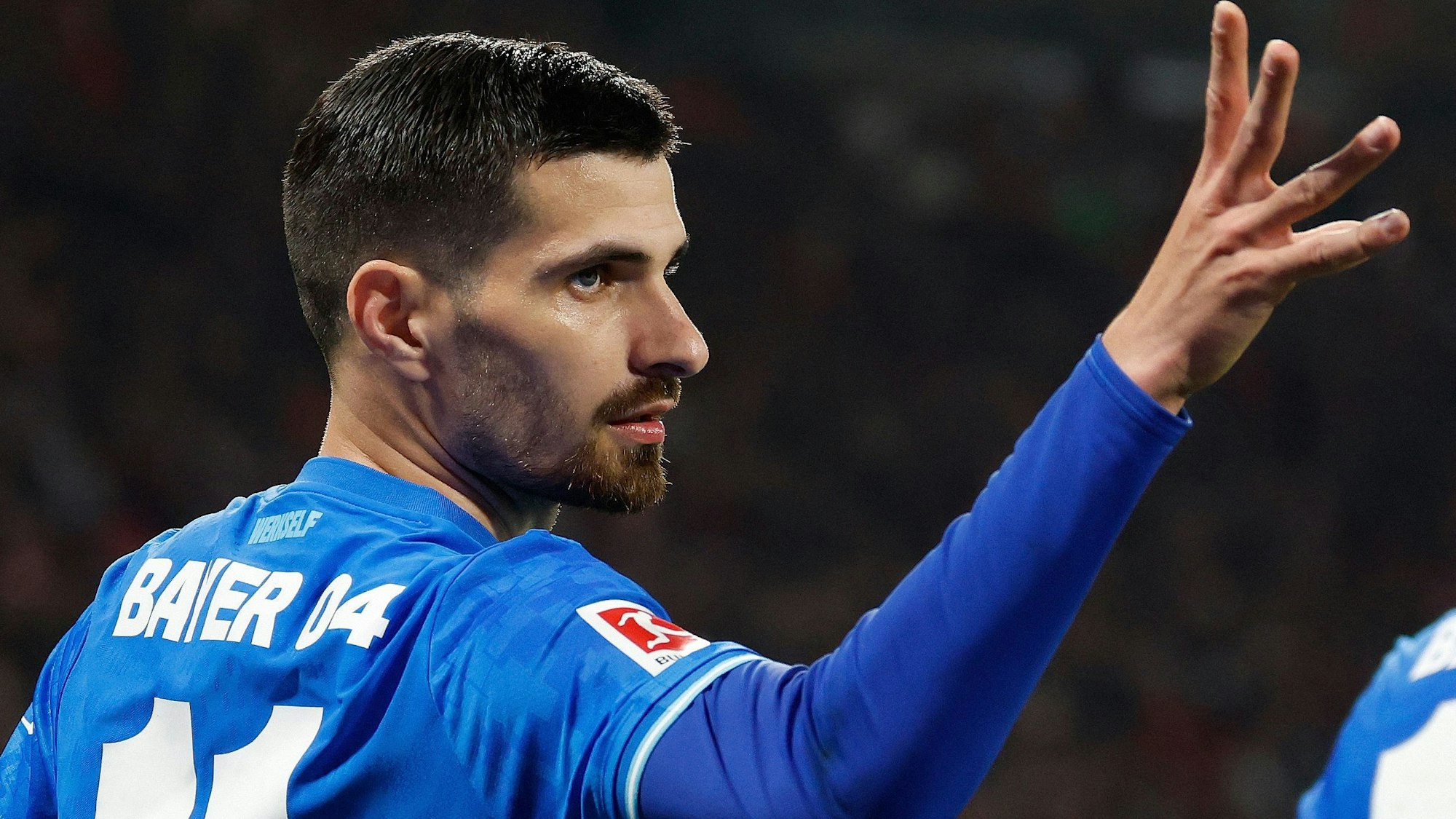 Bayer Leverkusen's French forward #11 Martin Terrier (L) celebrates scoring the 1-1 goal with his teammates during the German first division Bundesliga football match between RB Leipzig and Bayer 04 Leverkusen in Leipzig, eastern Germany, on December 20, 2025. (Photo by Odd ANDERSEN / AFP) / ALTERNATIVE CROP