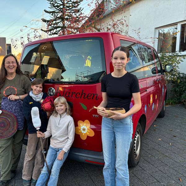 Ingrid Retterath und ihre drei Töchter stehen am VW-Bus der Familie, auf dem „Klärchen“ geschrieben steht.