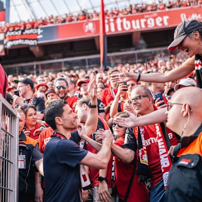 LEVERKUSEN, GERMANY - MAY 11: Xabi Alonso, Head Coach of Bayer 04 Leverkusen greets fans after the Bundesliga match between Bayer 04 Leverkusen and Borussia Dortmund at BayArena on May 11, 2025 in Leverkusen, Germany.