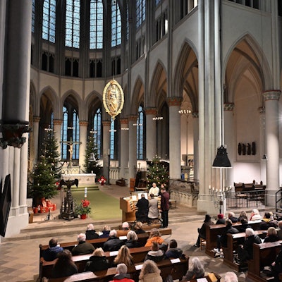 Der Altenberger Dom von innen mit zahlreichen Gästen auf den Bänken und zwei Organisten, festlich geschmückt.