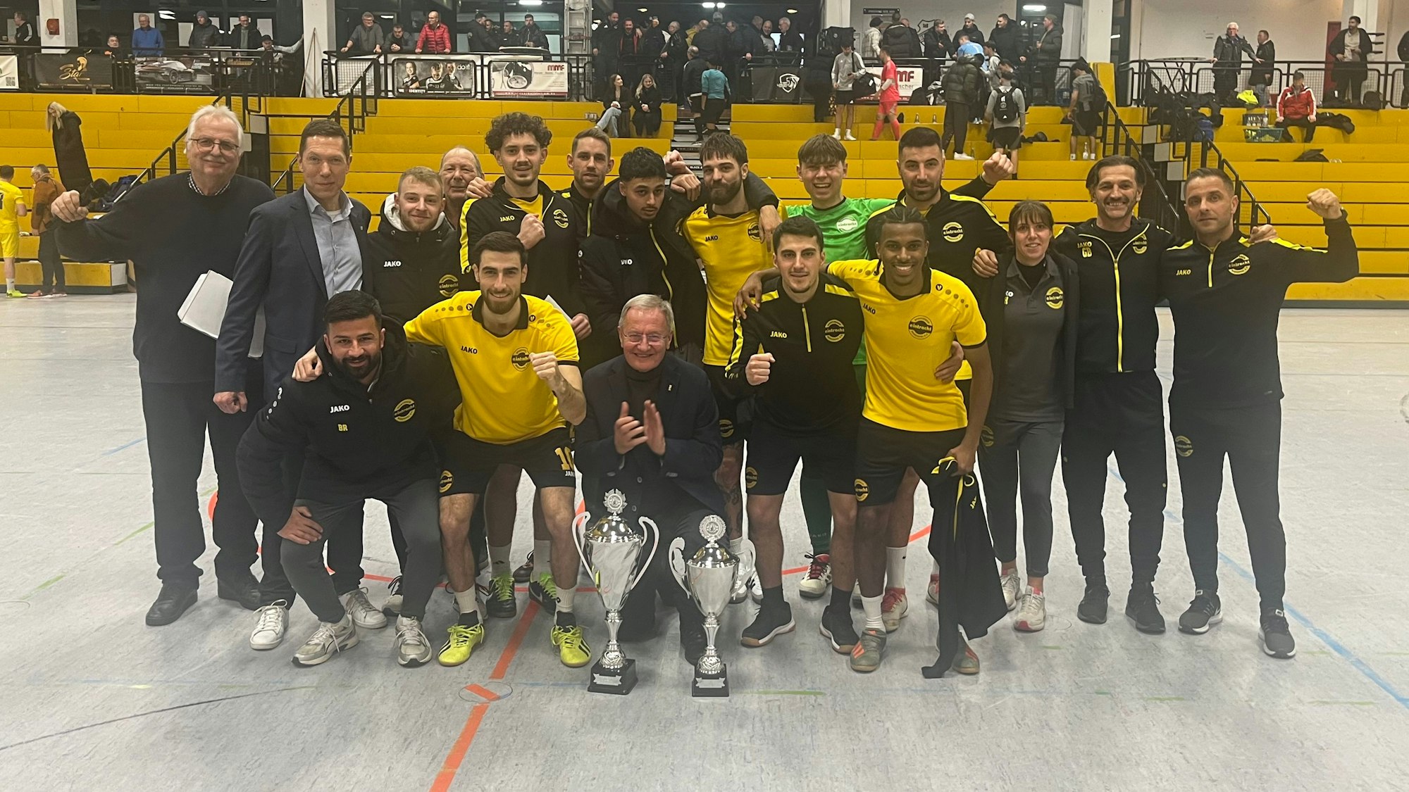 Zu sehen ist eine Fußballmannschaft, die ein Hallenturnier gewonnen hat.