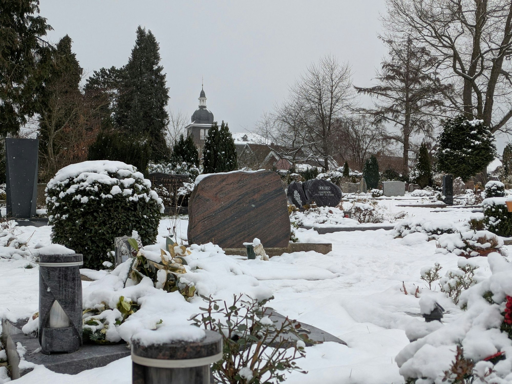 Der Friedhof Bergisch Neukirchen mit der evangelischen Kirche im Hintergrund