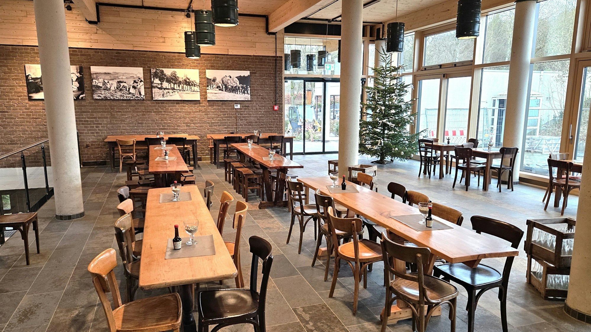 Blick in den großen Raum mit mehreren großen Tischen und Stühlen.