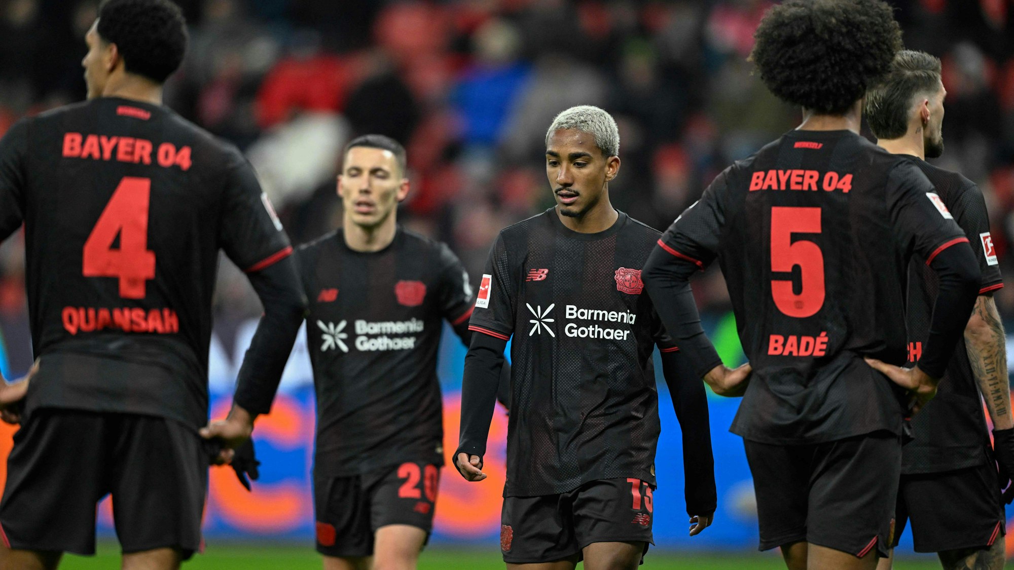 Bayer Leverkusen's Spanish defender #20 Alejandro Grimaldo (2nd L) celebrates scoring the 1-4 goal from the penalty spot with his teammates including Bayer Leverkusen's Brazilian defender #13 Arthur (C) during the German first division Bundesliga football match between Bayer 04 Leverkusen and 1 VfB Stuttgart in Leverkusen, western Germany, on January 10, 2026. (Photo by INA FASSBENDER / AFP) / DFL REGULATIONS PROHIBIT ANY USE OF PHOTOGRAPHS AS IMAGE SEQUENCES AND/OR QUASI-VIDEO
