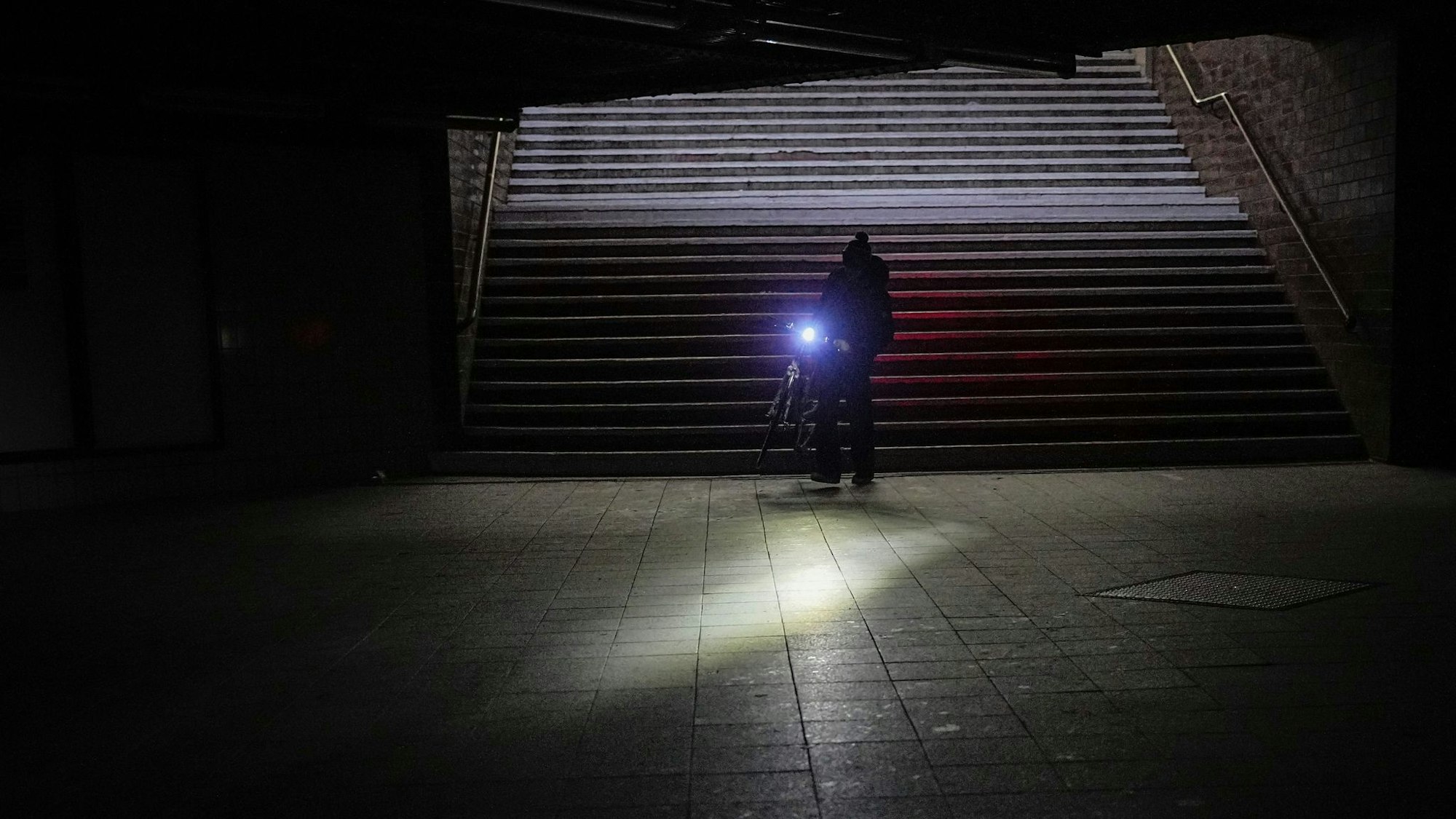 Im Stockdunkeln leuchtet eine Fahrradlampel.