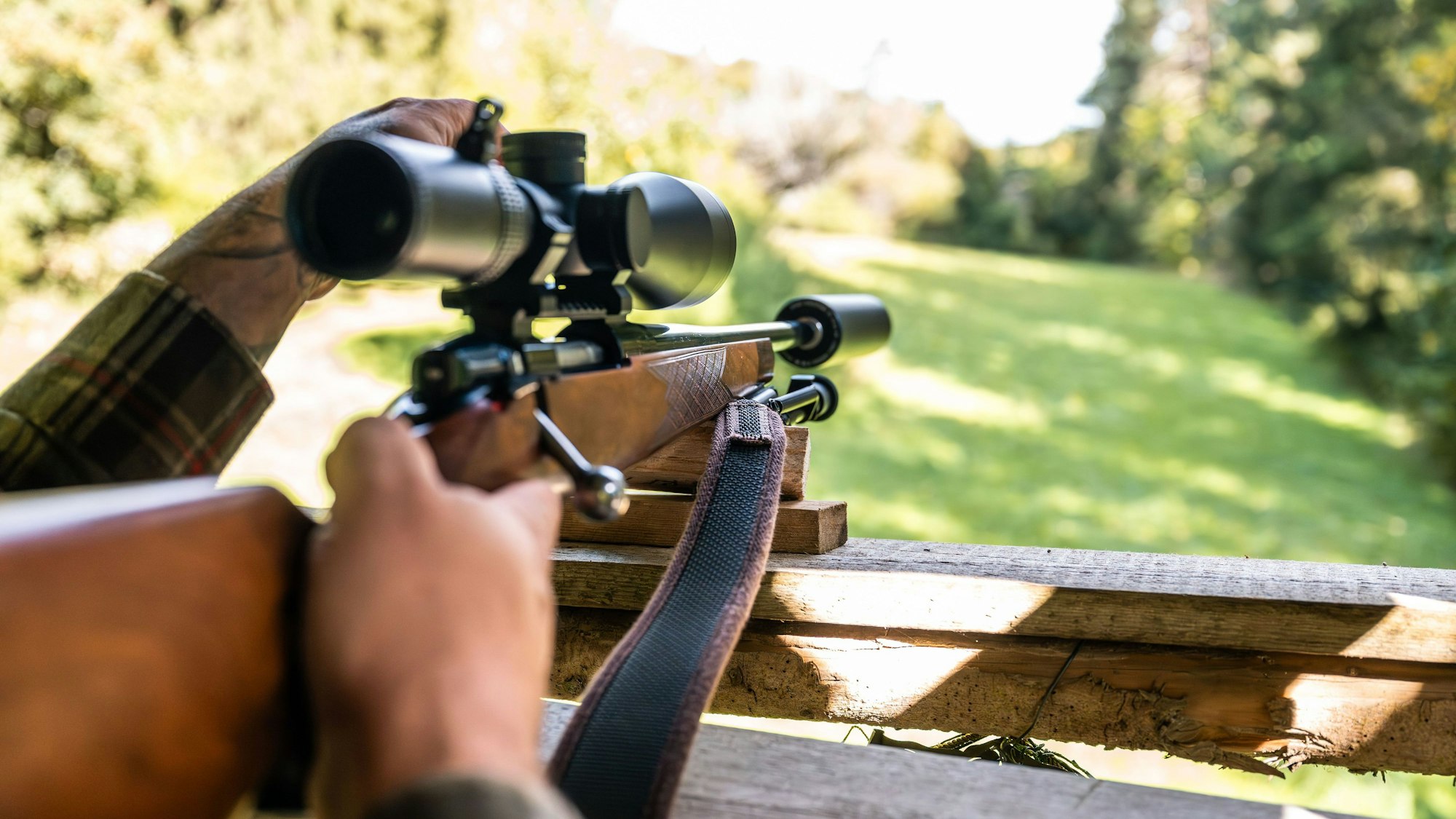 Ein Jäger hält in seinem Jagdrevier eine Jagdwaffe auf einem Hochsitz (Symbolbild). In Warburg hat ein Jäger versehentlich einen Kollegen erschossen.