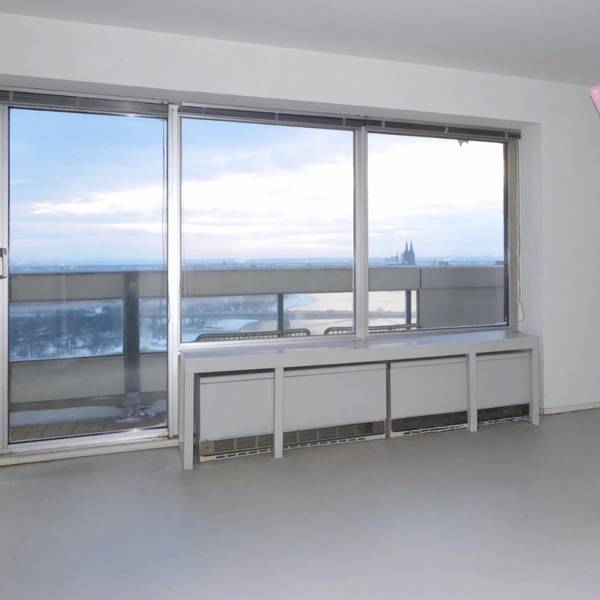 Eine rosafarbene Skulptur steht in einer Wohnung mit Domblick.