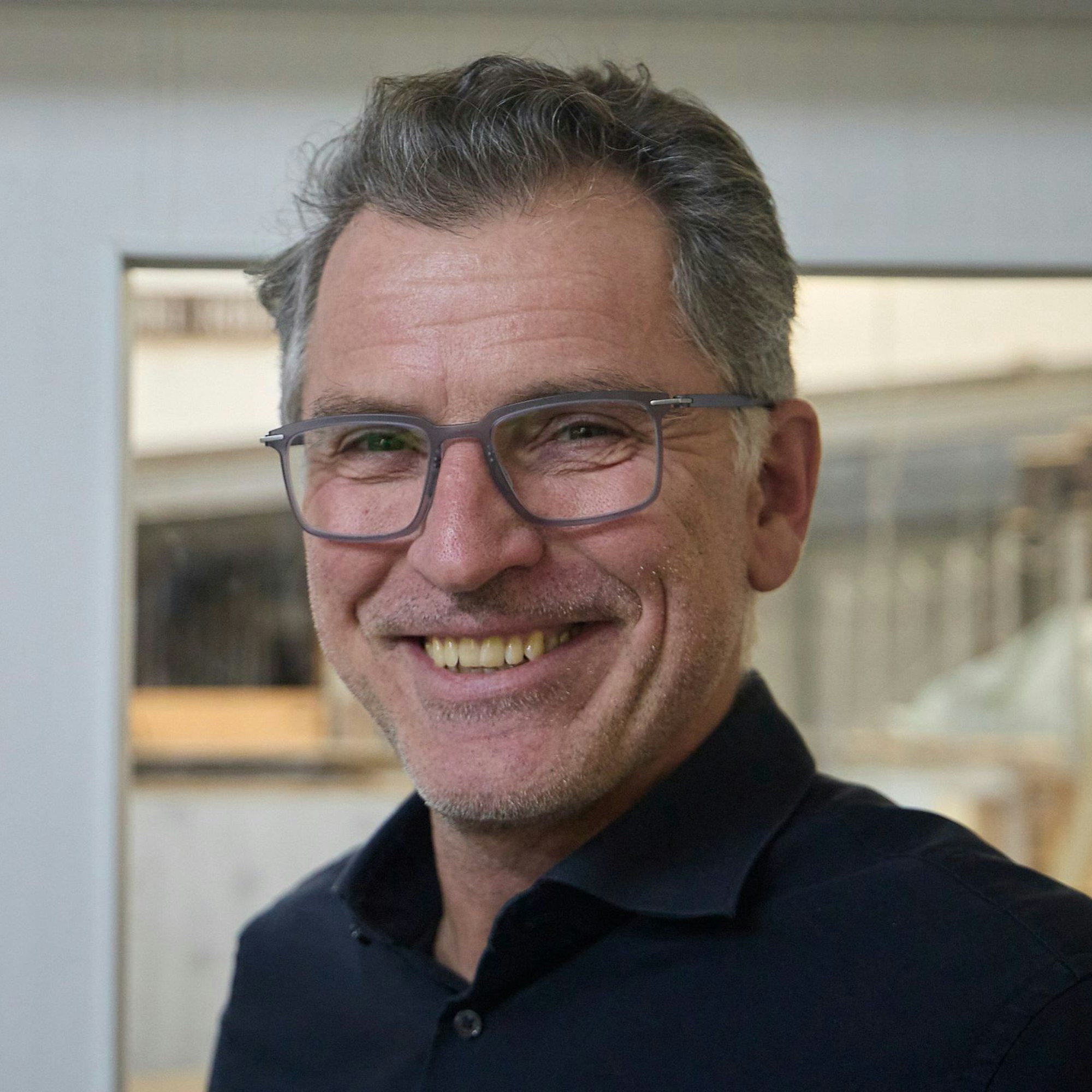 Porträtaufnahme von Frank Weimbs. Er trägt eine Brille und ein dunkelblaues Hemd.