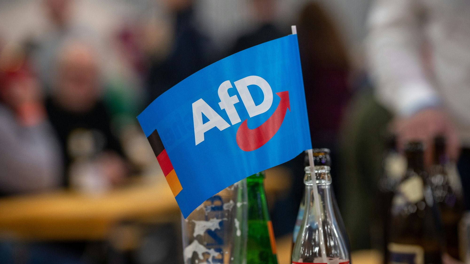 Ein Fähnchen der Alternative für Deutschland (AfD) steckt in einer Flasche bei einer Veranstaltung. (Symbolfoto)