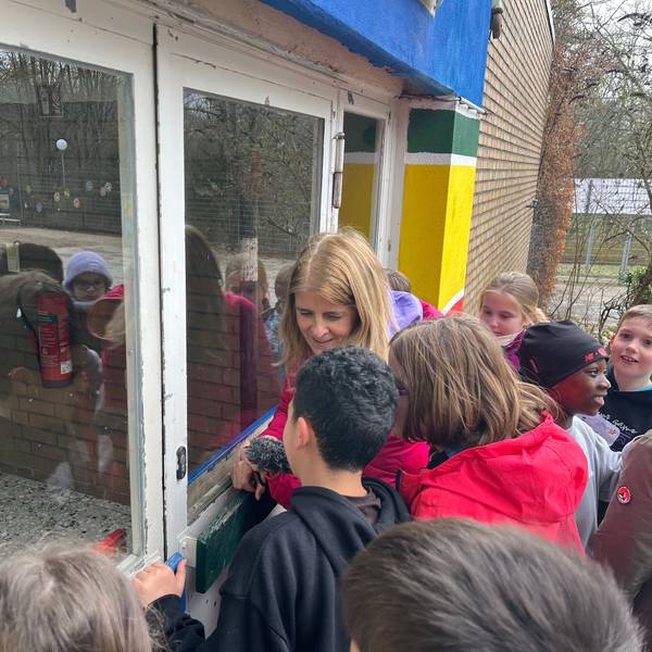 Reporterin Christina Pannhausen schaut mit Viertklässlern in das geschlossene OGS-Gebäude der Astrid-Lindgren-Schule