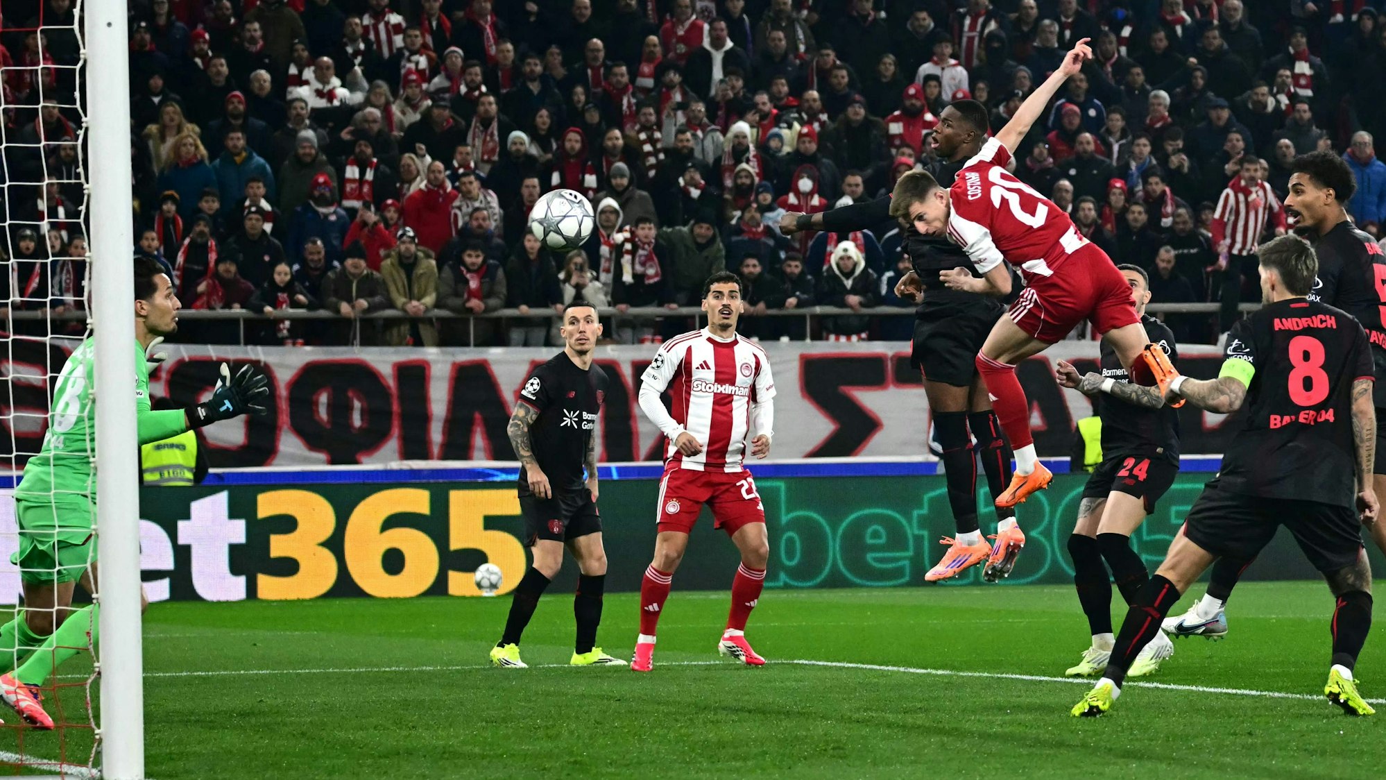 TOPSHOT - Olympiakos' Portuguese defender #20 Costinha heads the ball and score his team's first goal during the during the UEFA Champions League, league phase day 7, football match between Olympiakos and Bayer Leverkusen at the Georgios Karaiskakis Stadium in Piraeus, near Athens, on January 20, 2026. (Photo by Aggelos NAKKAS / AFP)