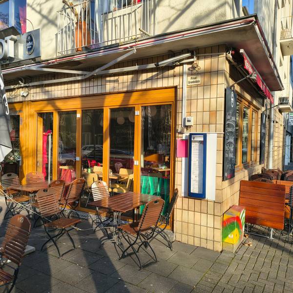 Vor einem Restaurant sind Stühle und Tische zu sehen.