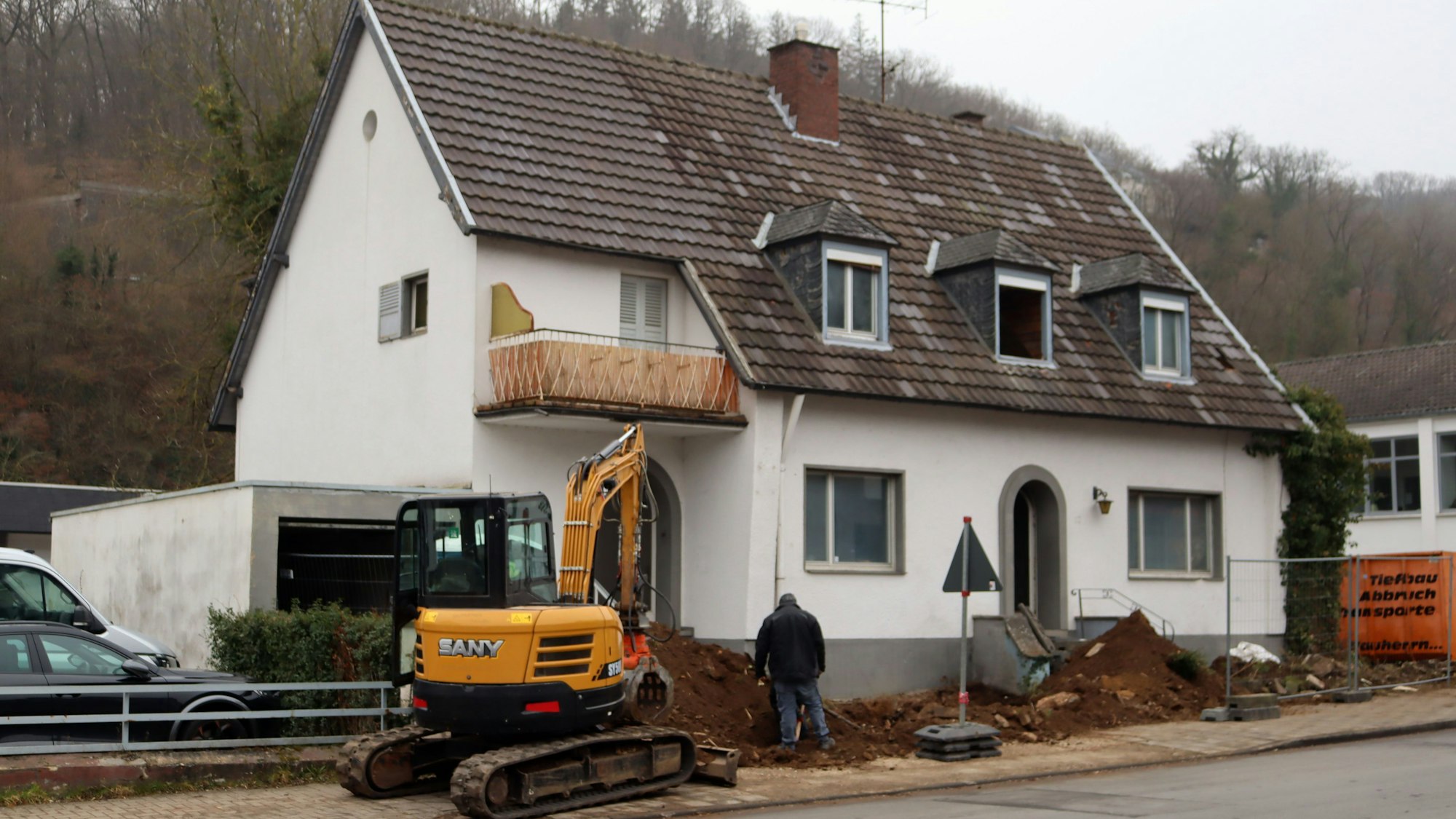 Ein Bagger steht vor dem Haus an der Kölner Straße, das derzeit abgerissen wird.